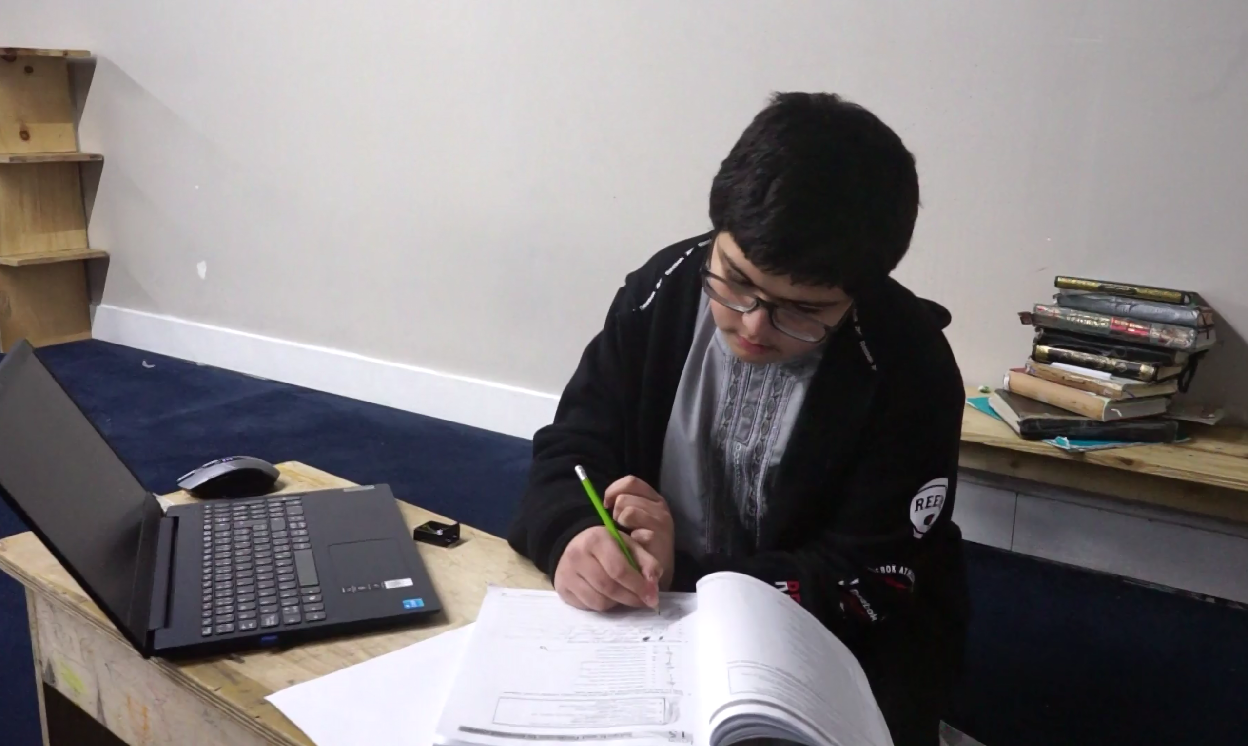 A student taking part in Islamic studies at Al-Ansaar