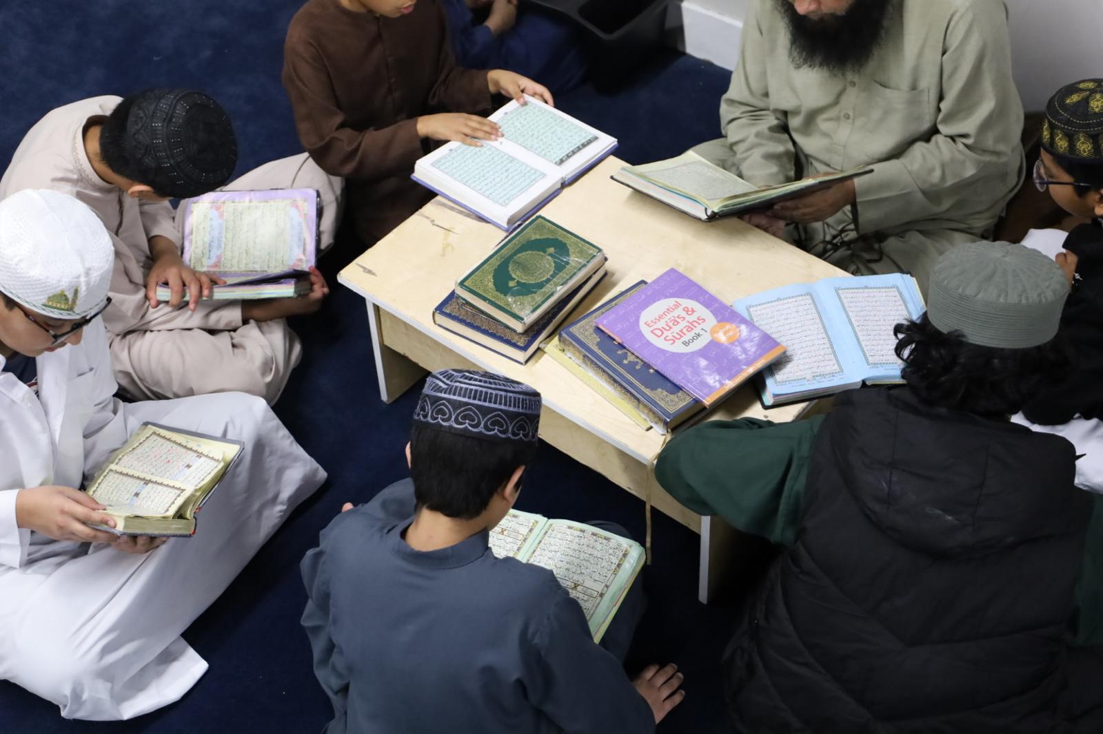 Children learning together in a shared classroom with their teacher